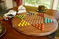16.5 inch wooden Chinese checkers board in walnut or cherry, with fancy marbles
