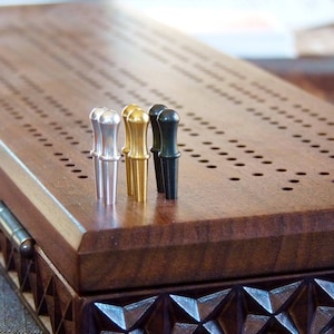 Carved walnut 3-track Cribbage board with storage for cards and pegs