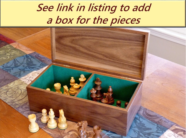 Walnut box for chess pieces is shown with the lid open revealing two compartments, one for light pieces, one for dark. Compartments are lined with green felt flocking. The box is available separately.