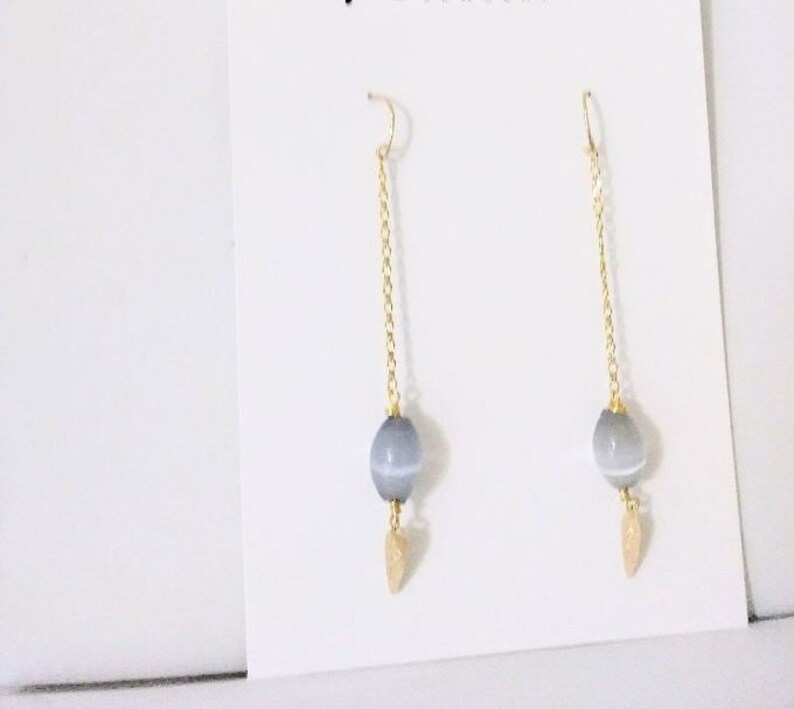 One Cat/'s Eyes Gray Crystal in a long 18K Gold Filled Chain hanging from a Gold Filled Wire Hook