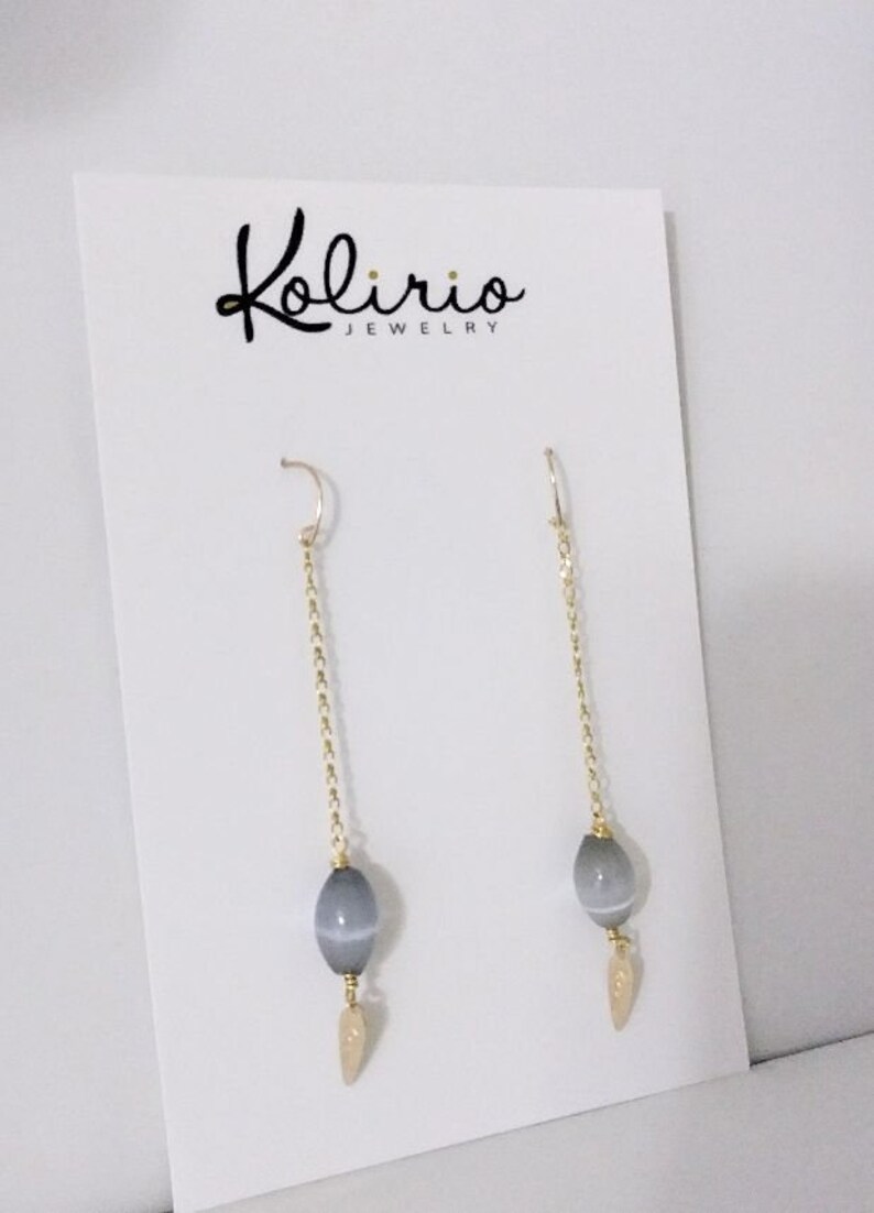 One Cat/'s Eyes Gray Crystal in a long 18K Gold Filled Chain hanging from a Gold Filled Wire Hook