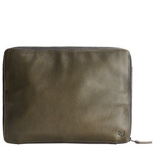 May include: A green leather laptop sleeve with a zipper closure. The sleeve has a small logo on the bottom right corner.