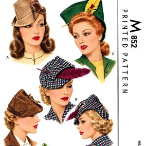 May include: A vintage sewing pattern envelope labeled M 852 Ladies' and Misses' Hats, featuring illustrations of various hat styles including a tan fedora, a green hat with a yellow feather, and plaid hats with dark feathers, for headsize 22.