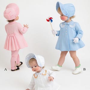 May include: Three children's outfits: a pink coat and pants set, a light blue coat with a bonnet, and a white coat with a bonnet. Accessories include a blue bow and pink flower hair clips. The outfits are suitable for babies and toddlers.