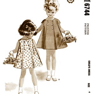 May include: Vintage sewing pattern for a child's dress, size 4. The pattern is printed and includes instructions for an easy-to-sew dress with a button-up front and a flared skirt. The pattern is illustrated with two girls wearing the dress.