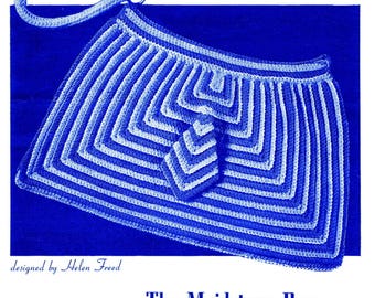 May include: A blue and white crocheted bag with a handle, featuring a geometric design. The bag is labeled "The Maidstone Bag" and is designed by Helen Freed. The design includes a flap with a matching pattern.