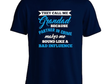 May include: Navy blue t-shirt with white and blue text. The text reads "THEY CALL ME Grandad BECAUSE PARTNER IN CRIME makes me sound like a BAD INFLUENCE". A humorous gift for grandfathers.