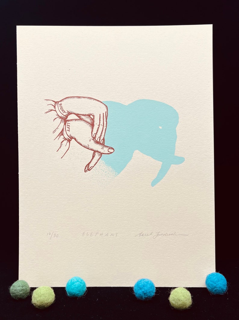 May include: A hand-drawn illustration of a hand making an elephant shadow puppet. The image is printed on cream-colored paper with a light blue elephant shadow. The print is numbered 14/30 and signed "Sarah Joncas".