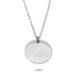 May include: A silver necklace with a round pendant featuring a fingerprint design. The pendant is engraved with a fingerprint pattern. The necklace is a great way to memorialize a loved one.