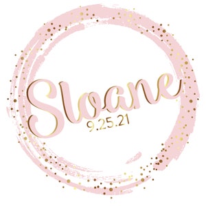 May include: Pink and gold circle with the name Sloane and the date 9.25.21.