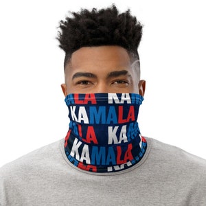 May include: A blue, red, and white face mask with the repeated text "Kamala" printed on it.