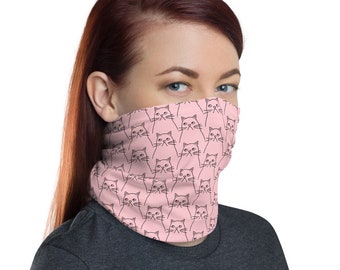 May include: A pink face mask with a repeating pattern of black line drawings of cats. The cats are looking directly at the viewer.