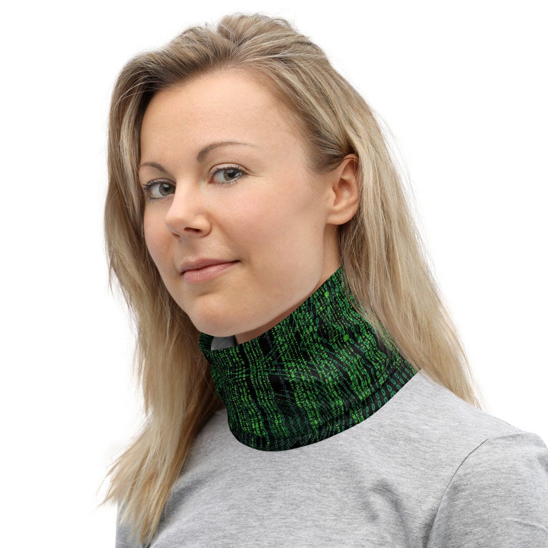 Peut inclure: Une femme portant un tour de cou noir et vert avec un motif de code vert. Le tour de cou est fait d'un mat&eacute;riau doux et extensible et est con&ccedil;u pour &ecirc;tre port&eacute; autour du cou pour la chaleur ou la protection contre les &eacute;l&eacute;ments.
