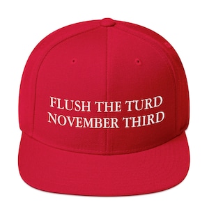 May include: Red baseball cap with white embroidered text that reads "FLUSH THE TURD NOVEMBER THIRD"