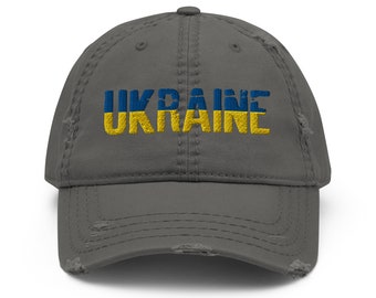 May include: A gray distressed baseball cap with the word "UKRAINE" embroidered in yellow and blue, the colors of the Ukrainian flag.