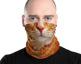 May include: Orange and white cat face neck gaiter. The gaiter features a realistic close-up of a cat's nose, mouth, and whiskers. The neck gaiter is made of a soft, stretchy material and is designed to be worn around the neck or face.