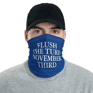 May include: A blue face mask with the white text "FLUSH THE TURD NOVEMBER THIRD" printed on it.