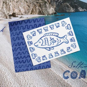 May include: A blue and white card with a fish illustration and a matching blue patterned card are displayed on a sandy beach. The words "Thank you" are written in cursive. The words "Saltwater Coast" are also visible.