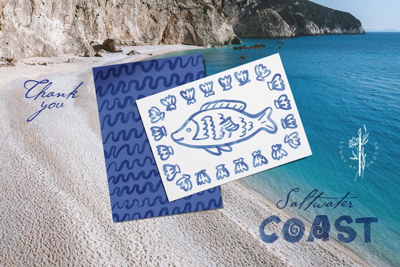 May include: A blue and white card with a fish illustration and a matching blue patterned card are displayed on a sandy beach. The words "Thank you" are written in cursive. The words "Saltwater Coast" are also visible.