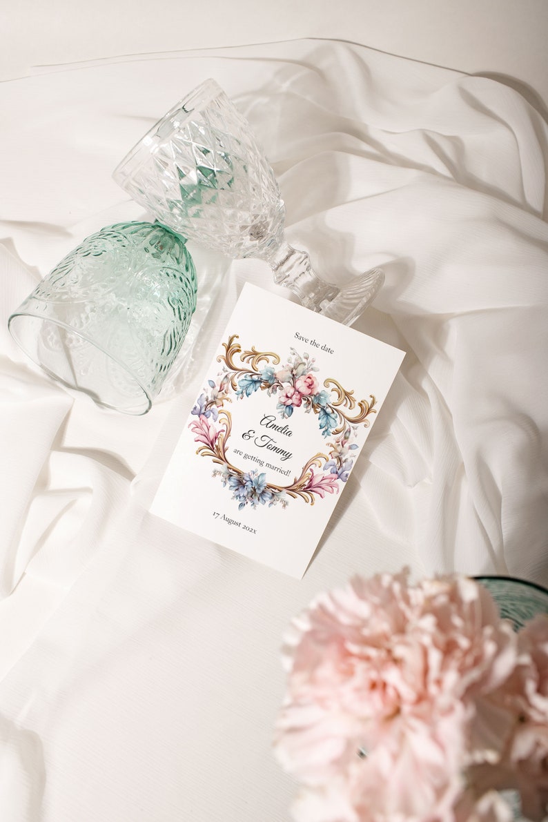 May include: Save the date card with a floral design and gold accents. The card says "Amelia & Tommy are getting married!" and "17 August 2022".