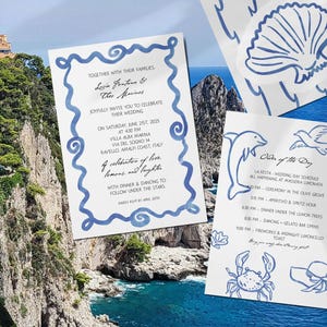 May include: Wedding invitation suite with a coastal theme. The invitation features blue watercolor wave borders and text. Additional cards include a seashell, dolphin, crab, and hat illustrations. The background shows a scenic view of the coast.
