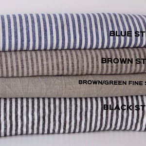 May include: Four different striped fabric swatches stacked on top of each other. The top swatch is blue and white striped, the second swatch is brown and white striped, the third swatch is brown and green striped, and the bottom swatch is black and white striped. The text on the swatches reads 'BLUE STRIPED', 'BROWN STRIPED', 'BROWN/GREEN FINE STRIPED', and 'BLACK STRIPED'.