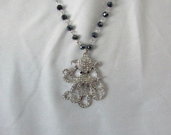 octopus rhinestone pendant on blue black beaded necklace