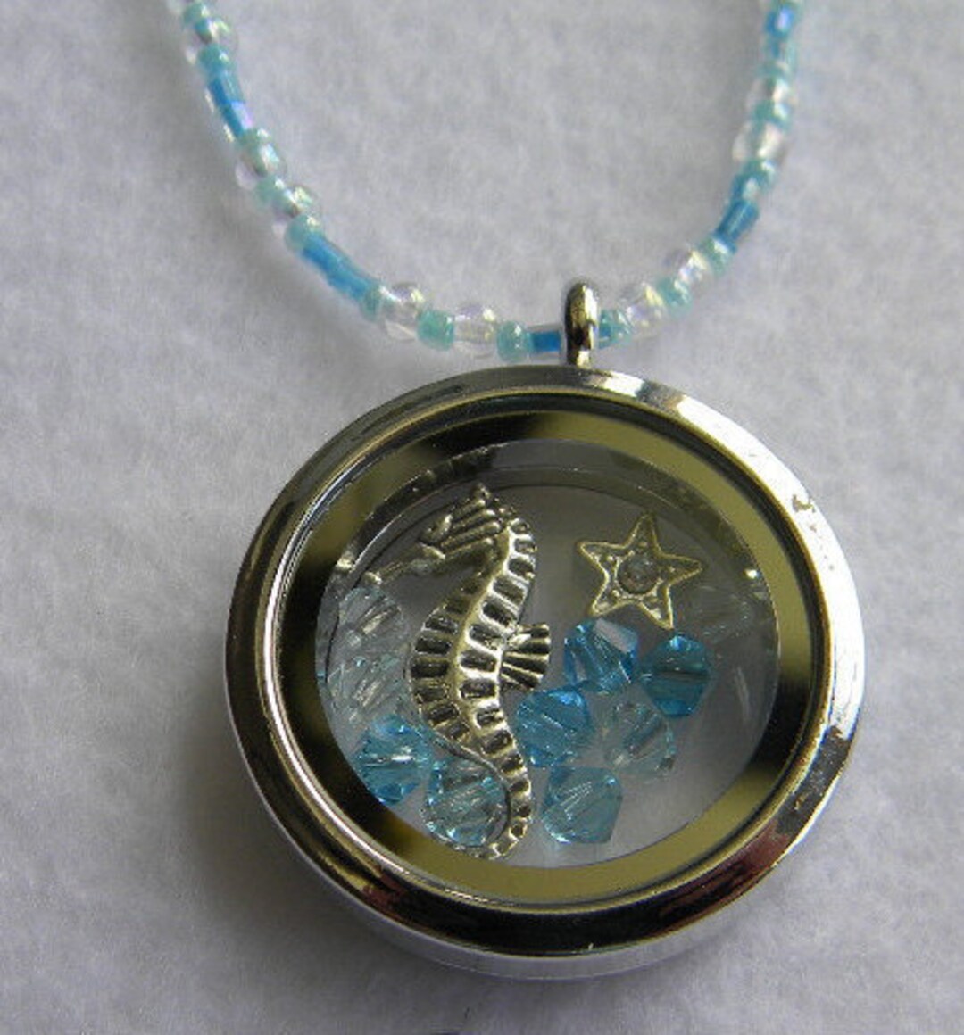 Fillable Glass Seahorse Pendant With Crystal Beads on a Blue and
