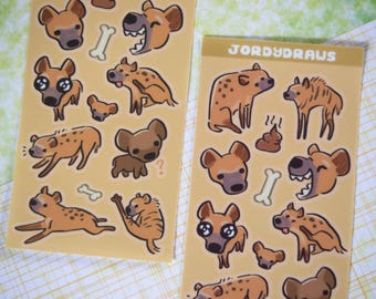May include: A sheet of stickers featuring various cartoon hyenas in different poses. The stickers are on a yellow background with the text "JORDYDRAUS" in black at the top of the sheet.