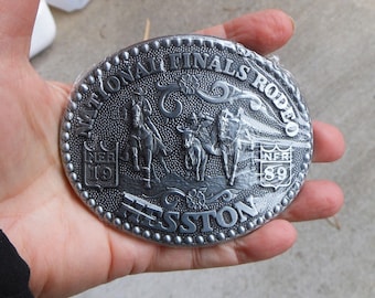 1989 Hesston Rodeo Belt Buckle National Finals Rodeo Buckle - NOS Still in Wrapper With Paperwork - Shows Steer Wrestling