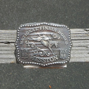 1986 Hesston Rodeo Belt Buckle Miniature or Junior Size National Finals Rodeo Buckles - NOS Still in Wrapper With Information Sheet