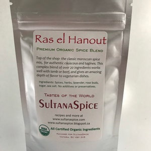 May include: A silver stand-up pouch containing Ras el Hanout premium organic spice blend. The label features the text Ras el Hanout, Premium Organic Spice Blend, SultanaSpice, and lists ingredients including spices, herbs, lavender, rose buds, sugar, and sea salt.