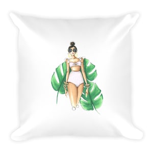 May include: A white and pink gingham bikini with white ruffle trim and a white top. The model is wearing large black sunglasses and gold hoop earrings. The model is standing in front of a large green tropical leaf.