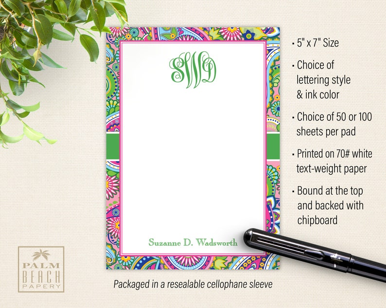 May include: A personalized notepad with a paisley design in pink, green, and blue. The notepad is 5 inches by 7 inches and has a monogram in green. The notepad is packaged in a resealable cellophane sleeve.