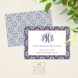 May include: A blue and white patterned business card with a coral border. The card features a monogram "PHB" in a script font and the text "Paige Barrett Hutchins (561) 301-3745 paigehutchins@gmail.com". The bottom of the card has the text "PALM BEACH PAPERY" in a smaller font.