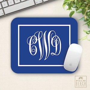 May include: A blue mouse pad with a white border and a white monogram in the center. The monogram is a cursive "CWD".