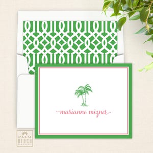 May include: Green and white patterned stationery envelope with a green and white palm tree design on a white card with the text "marianne mizner" in pink.