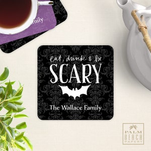 May include: Black and white Halloween-themed coaster with a damask pattern. The text reads "eat, drink & be SCARY" with a bat silhouette. The bottom of the coaster says "The Wallace Family".