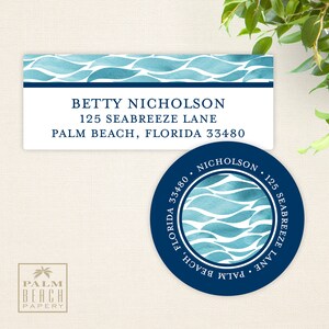 May include: A blue and white watercolor design with waves on a white background. The design is on a rectangular label and a round sticker. The label has the text "BETTY NICHOLSON, 125 SEABREEZE LANE, PALM BEACH, FLORIDA 33480". The sticker has the text "NICHOLSON, 125 SEABREEZE LANE, PALM BEACH, FLORIDA 33480".