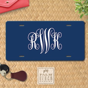 May include: A navy blue personalized license plate with white monogram initials "RWK" in a script font.