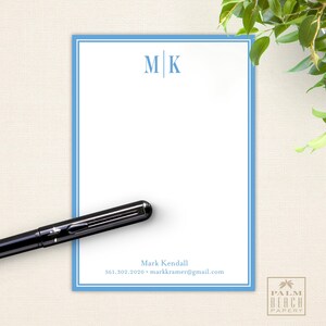 May include: Blue and white personalized stationery with a blue border and the monogram "M|K" at the top. The stationery includes the name "Mark Kendall" and the email address "markkramer@gmail.com" at the bottom.