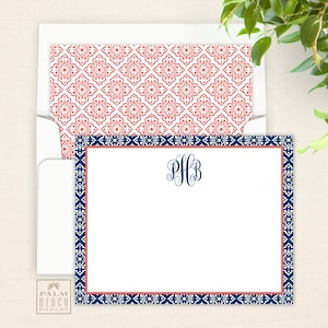 May include: A white card with a blue and coral border. The card has a navy blue monogram in the center that says "PHB".