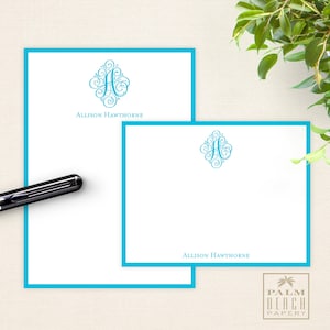 May include: Two white stationery note cards with a turquoise border. The top card has a decorative monogram with the letter "A" and the name "Allison Hawthorne". The bottom card has the same monogram and the name "Allison Hawthorne".