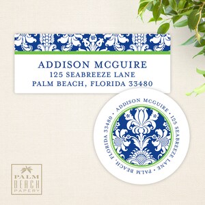 May include: Two address labels with a blue and white floral pattern. The top label has the text "ADDISON MCGUIRE, 125 SEABREEZE LANE, PALM BEACH, FLORIDA 33480". The bottom label is a round sticker with the same floral pattern and the text "ADDISON MCGUIRE, 125 SEABREEZE LANE, PALM BEACH, FLORIDA 33480".