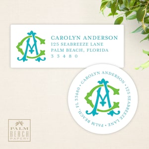 May include: A white return address label with a teal and green monogram of the letters "CA" in a decorative font. The text "CAROLYN ANDERSON 125 SEABREEZE LANE PALM BEACH, FLORIDA 33480" is printed below the monogram.