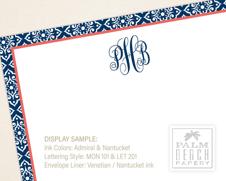 May include: A display sample of personalized stationery with a navy blue and coral border. The monogram is "PFB" in navy blue. The text reads "DISPLAY SAMPLE: Ink Colors: Admiral & Nantucket Lettering Style: MON 101 & LET 201 Envelope Liner: Venetian / Nantucket ink" and "PALM BEACH PAPERY".