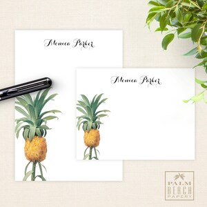 May include: Two white stationery note cards with a pineapple illustration and the name "Monica Parker" in cursive script. The cards are part of a set from Palm Beach Papery.
