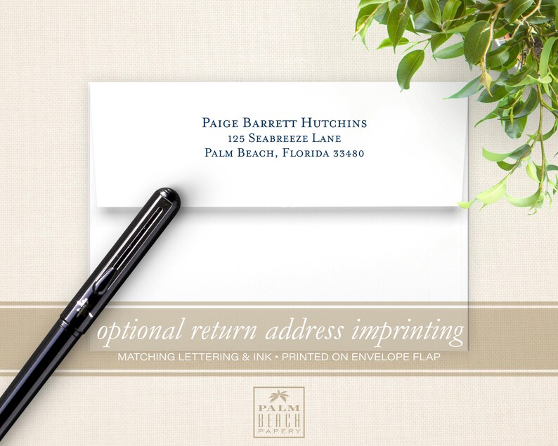 May include: A white envelope with a blue return address printed on the front flap. The address reads "Paige Barrett Hutchins, 125 Seabreeze Lane, Palm Beach, Florida 33480". The envelope is lying flat on a beige surface with a black pen next to it. The text "optional return address imprinting" is printed in brown on a beige background below the envelope. The text "Matching lettering & ink - printed on envelope flap" is printed in brown on a beige background below the previous text. The text "PALM BEACH PAPERY" is printed in brown on a beige background below the previous text.