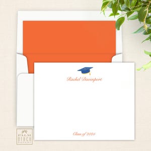 May include: White graduation announcement card with an orange envelope. The card features a blue graduation cap with a gold tassel and the text "Rachel Davenport" and "Class of 2025".