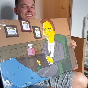 May include: A person holding a canvas print of a cartoon character sitting in a therapist's office. The cartoon character is yellow with black hair and is wearing a grey suit. The canvas print is wrapped in plastic.